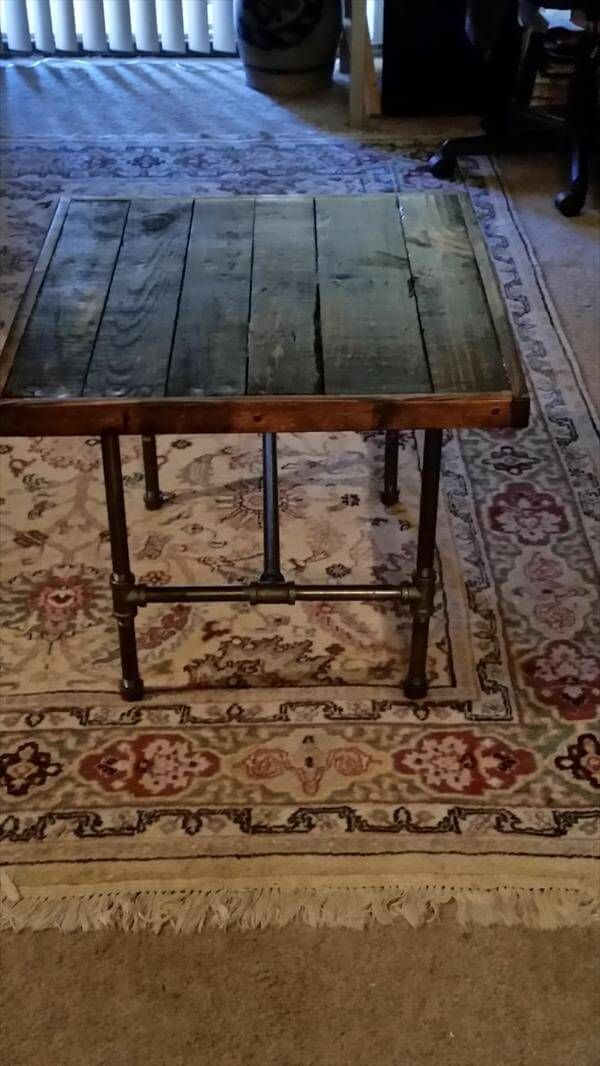 repurposed pallet table with metal iron pipe legs