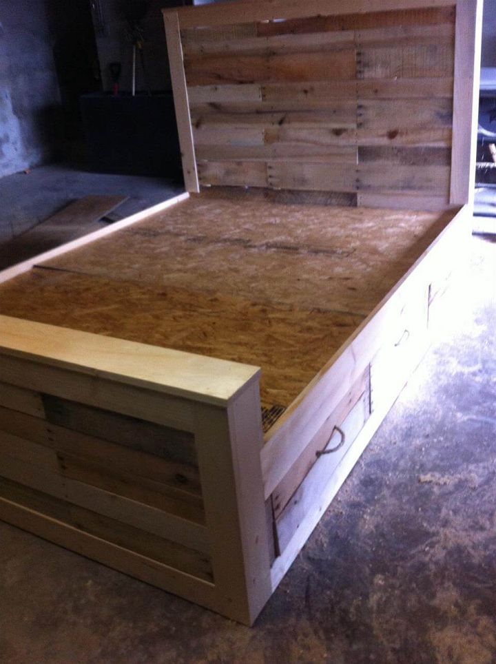 Repurposed pallet bed with drawers and headboard