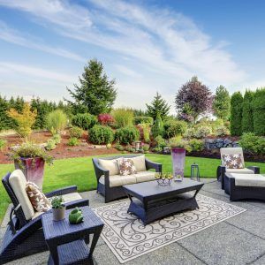 Impressive backyard landscape design with patio area